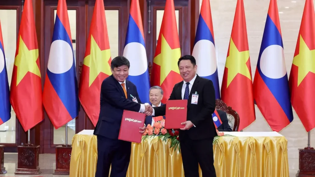 Vietjet Air (VJ) and Laos' Ministry of Public Works and Transport signed an agreement to enhance air connectivity between Vietnam and Laos. The ceremony in Vientiane includes high-ranking officials from both countries.