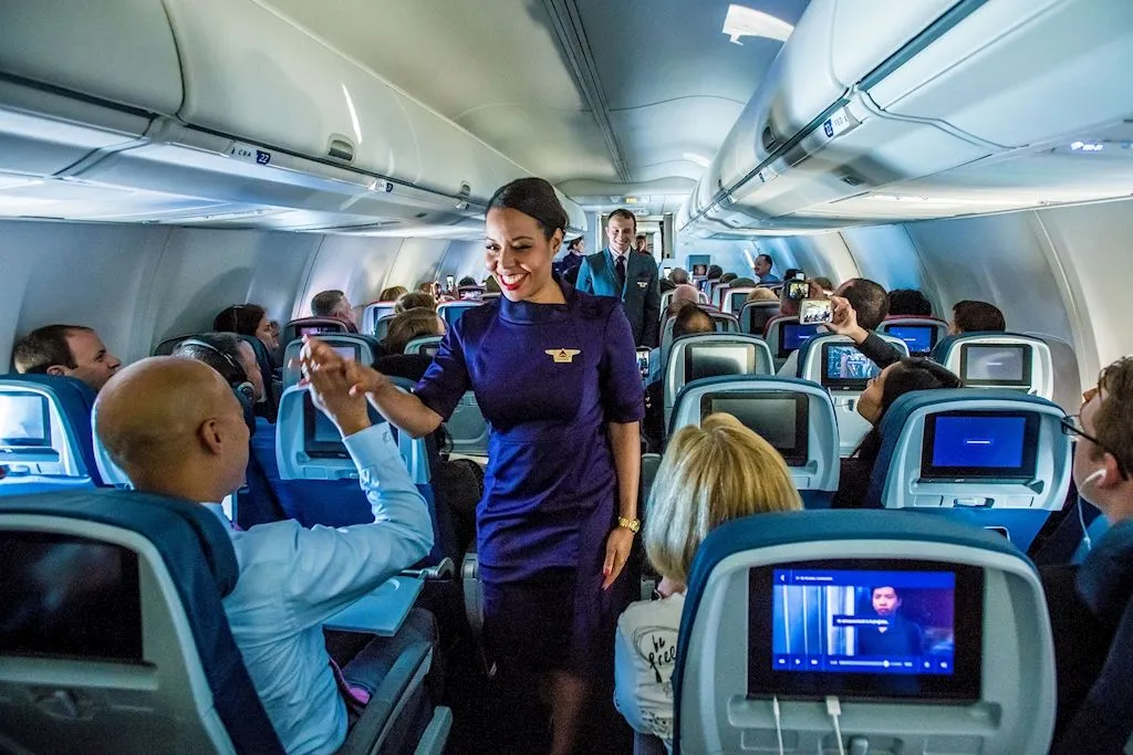 Delta Air Lines flight attendant attending to passengers