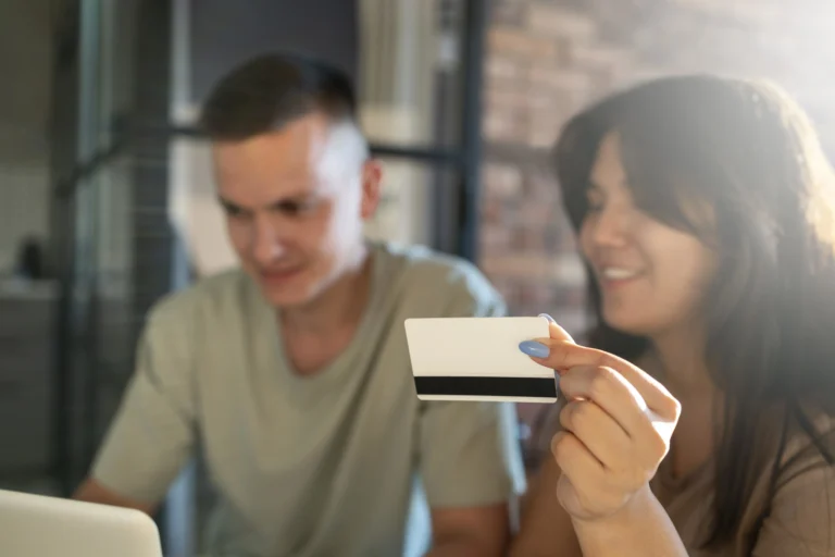Man and woman using credit card for online billing