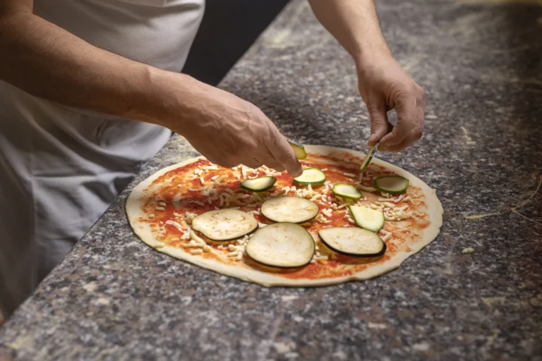 This Italian City is Top Destination for Gluten-Free Food Lovers in the World Chef preparing Neapolitan pizza