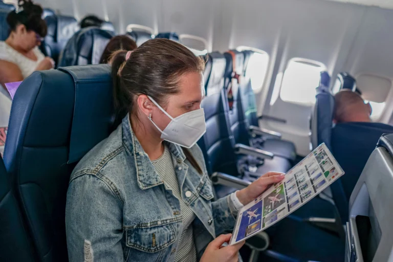 7 Dirtiest Spots on Plane But You Cannot Avoid Them A passenger reading airplane safety instruction card