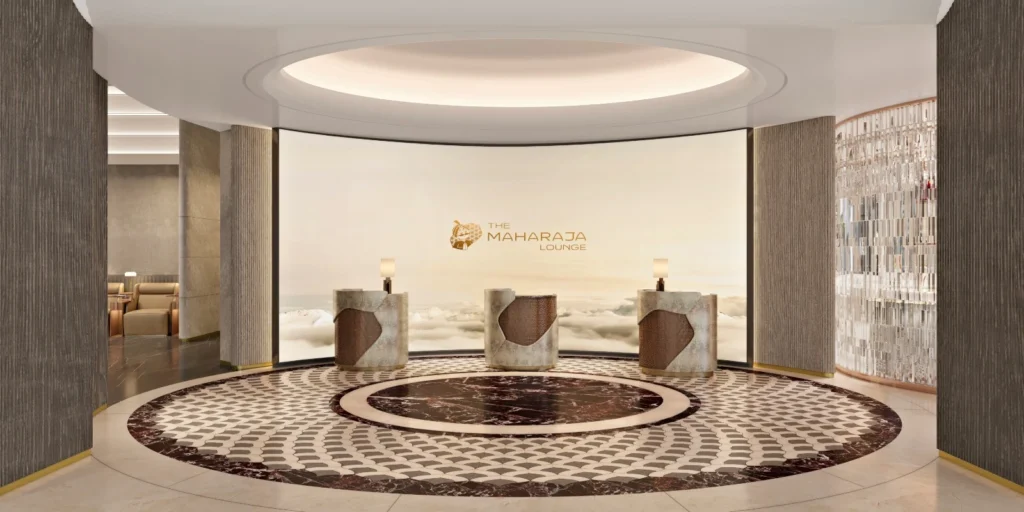 Air India (AI) is preparing a major upgrade for premium travelers as it plans to open a new Maharaja Lounge at Delhi Airport (DEL). The project aligns with the airline’s broader push to improve in-flight and on-ground services. The lounge expansion comes as Air India updates its global network and enhances its menus, with the new Delhi Airport (DEL) facility joining a growing list of refreshed premium spaces. Premium Lounge Expansion at Delhi’s International Hub Air India is developing a new Maharaja Lounge inside Terminal 3, designed for first class and business class passengers, along with eligible Maharaja Club members. Reports indicate the lounge is scheduled for a December 2025 opening. The airline already operates a Maharaja Lounge at Bengaluru Airport, and the Delhi addition reflects Air India’s renewed focus on a consistent premium experience across major hubs. The airline is also planning a dedicated domestic lounge for Terminal 3. This facility is expected in the second half of 2026 and is part of a wider plan to build a refreshed global lounge network across Bengaluru, Delhi, New York, and San Francisco. Leadership has confirmed that these lounges aim to support a modern, elevated ground experience matching recent improvements in aircraft interiors and inflight service. International Lounge Network Upgrades Air India is progressing with upgrades to its international lounges as well. Work is underway at John F. Kennedy Airport in New York with completion targeted for March 2026. Construction is also active at San Francisco International Airport, expected to finish by February 2026. These lounges are planned to serve premium travelers with quiet zones, improved service design, and expanded comfort amenities. Existing Lounge Experience in Bengaluru The Bengaluru Airport lounge in Terminal 2 is already open and serves as a model for the coming network. It features quiet work areas, strong Wi-Fi, power outlets, shower facilities, free dining options, and responsive staff. The layout aims to give travelers a calm space to work or relax with consistent service standards and a comfortable environment. Enhanced Onboard Experience Air India is upgrading its in-flight food and beverage program across international routes. A refreshed domestic menu is scheduled for early 2026. These improvements are part of a broader service redesign intended to offer a more refined and reliable onboard experience.