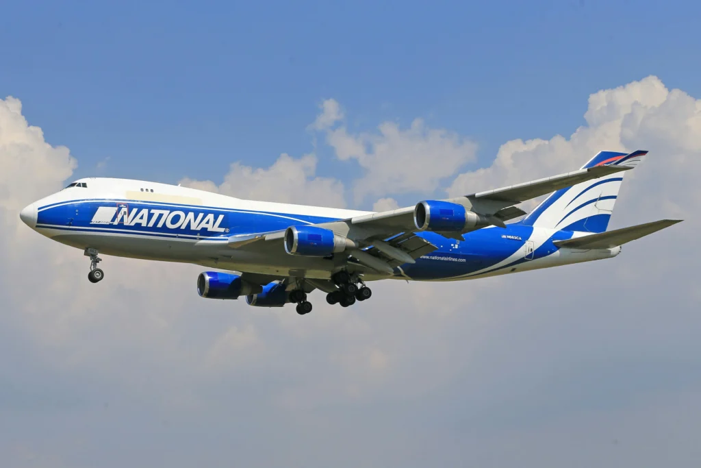 A National Airlines Boeing 747 diverted to JFK after an engine fire indication, completing a safe landing with coordinated ATC support.